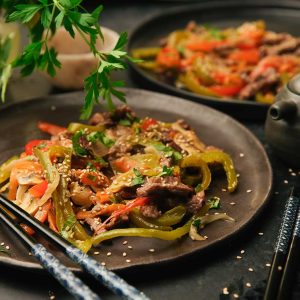 Oriental beef stir-fry with vegetables in a wok